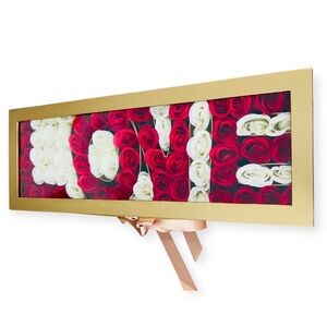 Stunning arrangement of silk red and white roses spelling out LOVE in a gift box